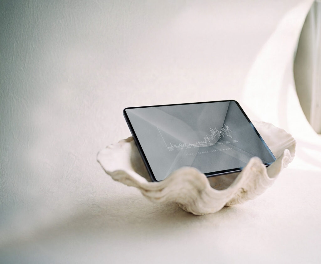 a clam shell holding an ipad with a white backdrop. The laptop is showing high performing SEO stats for photographers