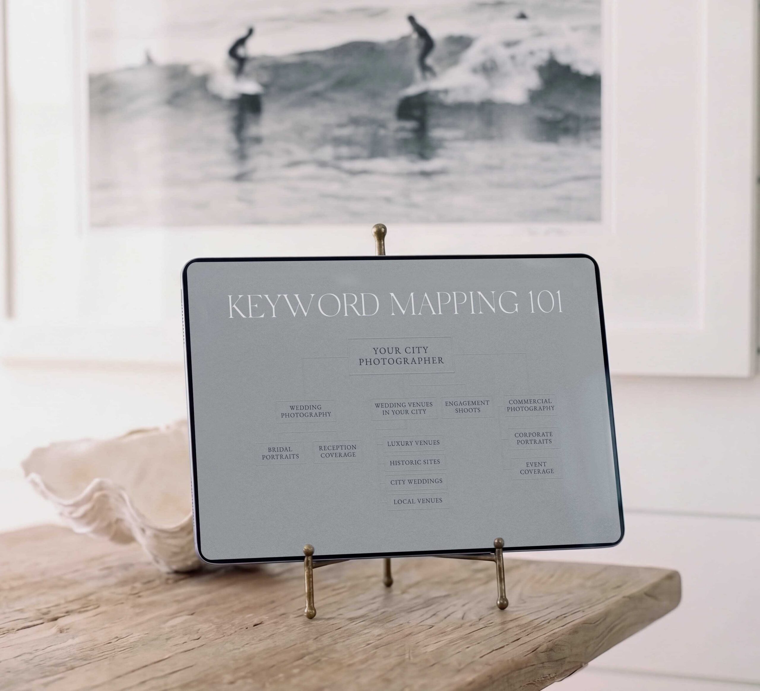 Ipad holds a keyword mapping example for SEO for Photographers. In a coastal office by High Tide Strategy Mandy Ford.