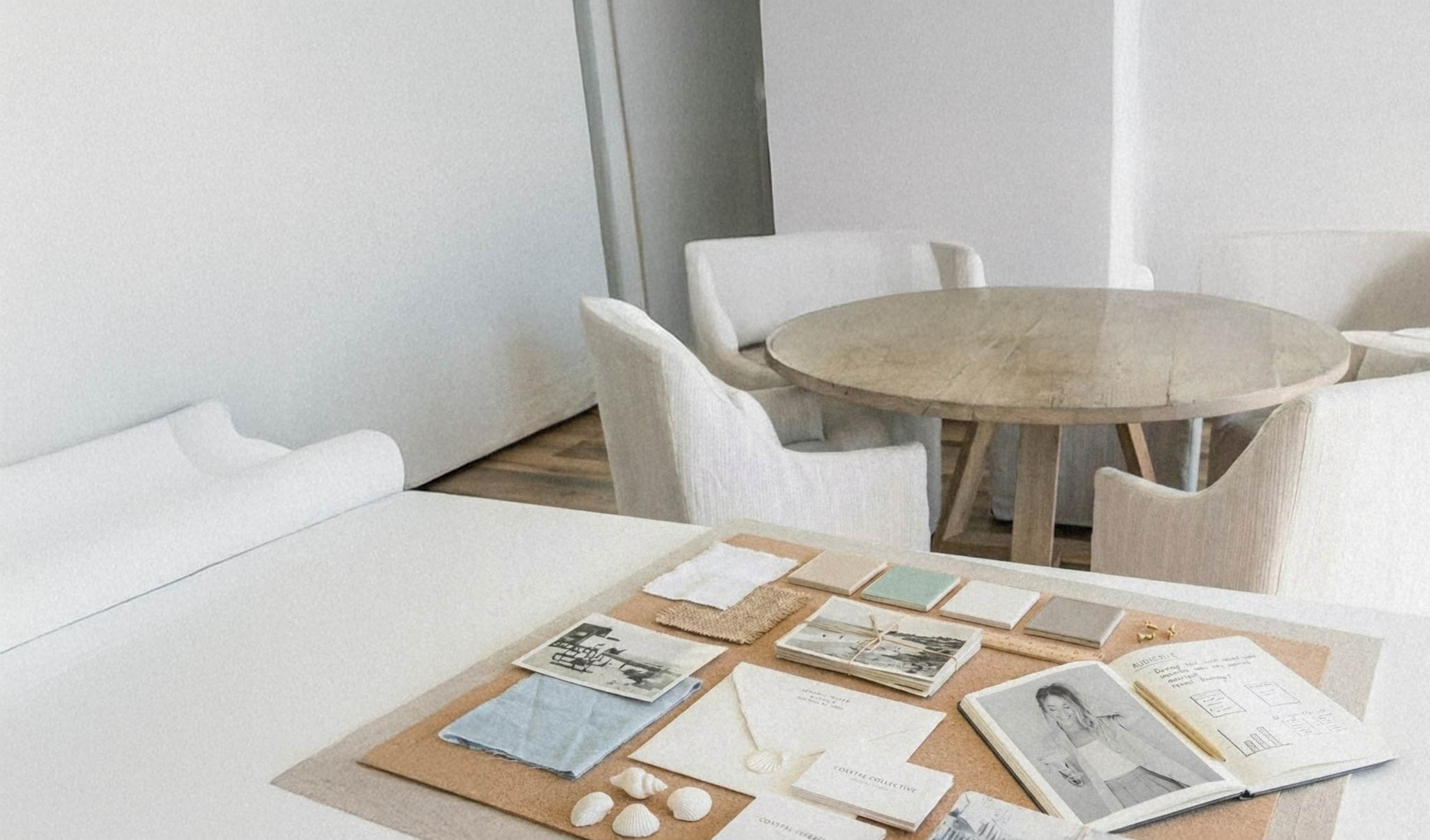 a mood board in a bright coastal office planning SEO strategy for photographers by top SEO Expert Mandy Ford