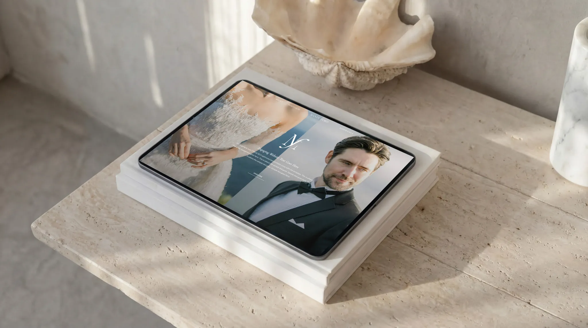 Tablet displaying a luxury Showit wedding photography website design mockup on an editorial marble table