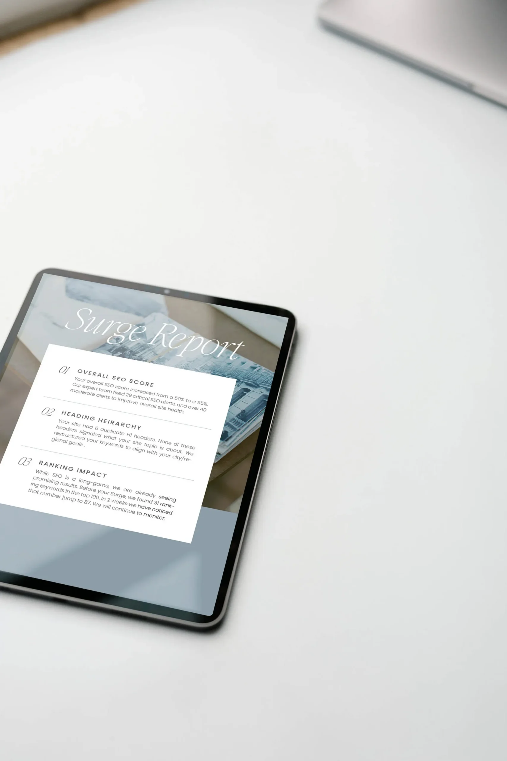 Tablet displaying a SEO report with insights and rankings on a white desk